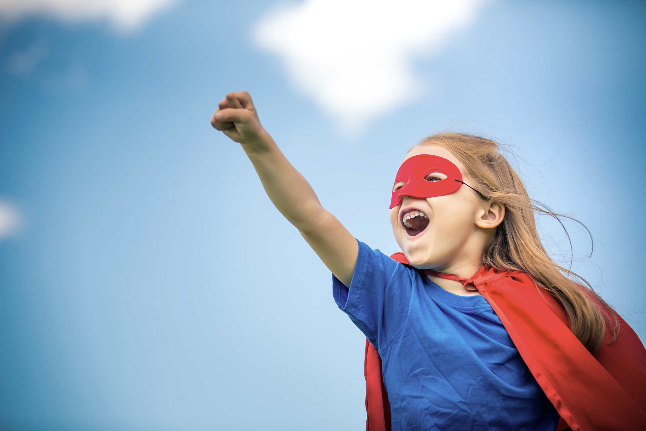 Kleines Mädchen als Superheldin in der Professionellen Zahnreinigung für Kinder